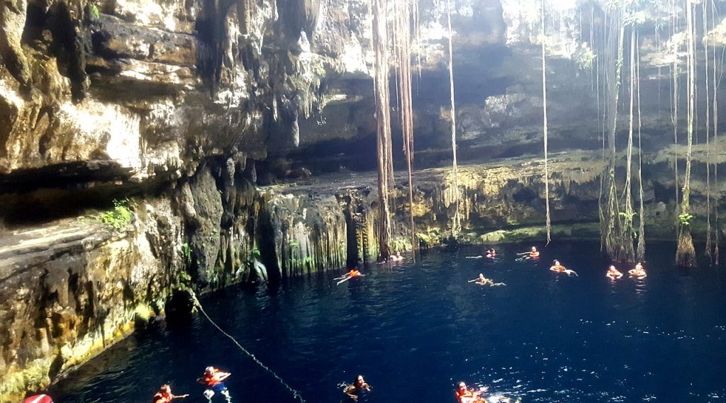 Swimmers in an open cenote in the Yucatan
